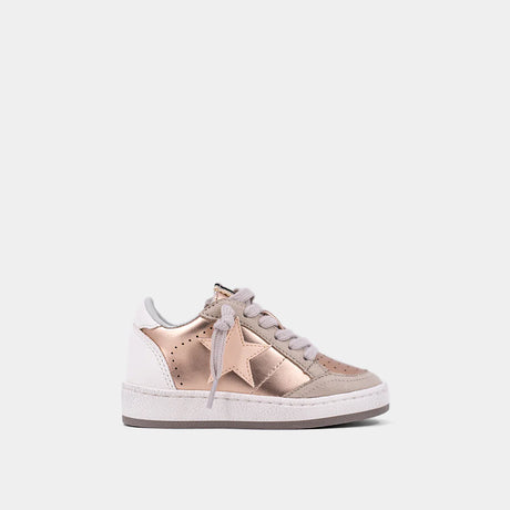 Sneaker with rose gold star design on a white background